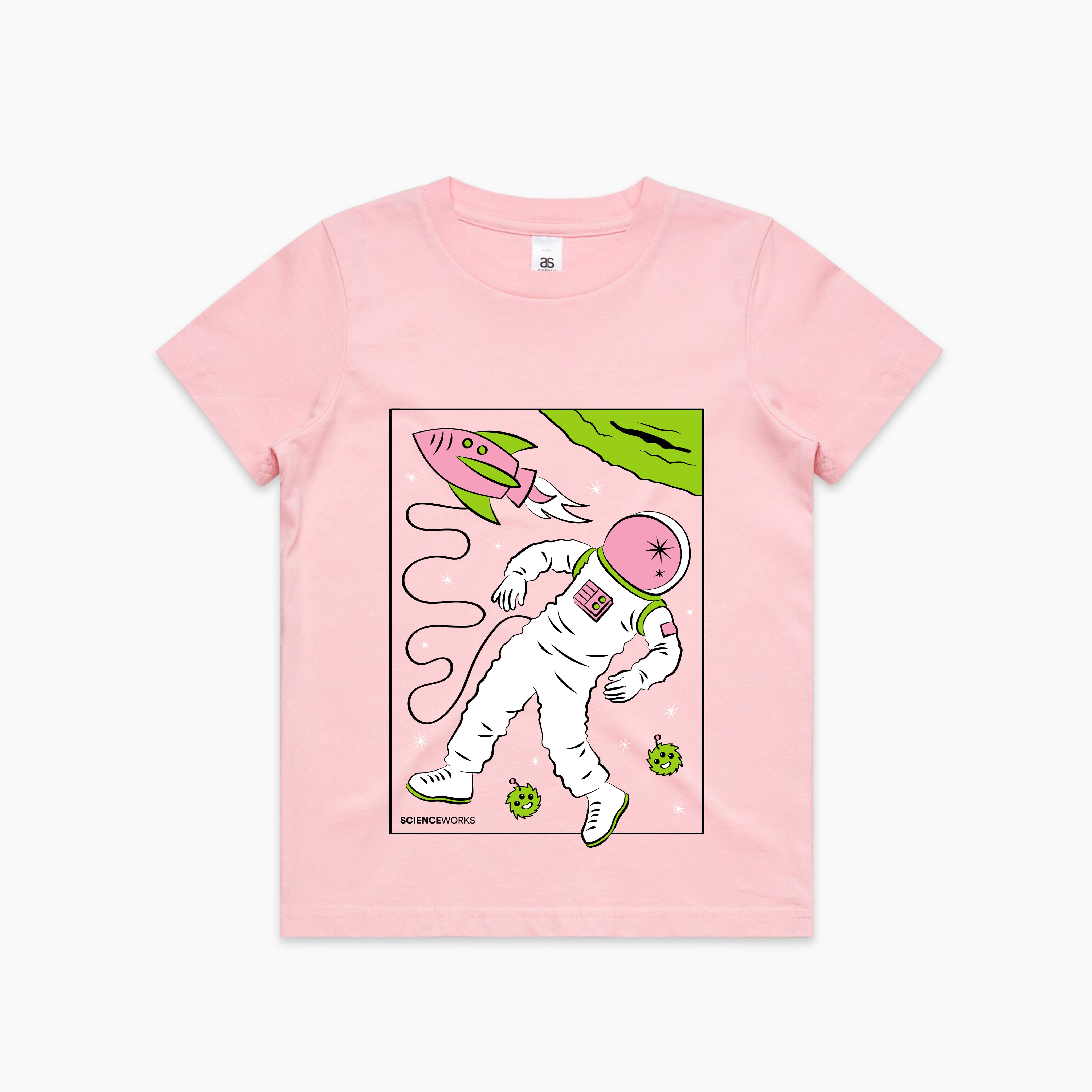 A baby pink kids tshirt with an image on the centre front. An astronaut is tethered to a green and pink rocket, floating next to a green planet. Two small three-eyed fluffy creatures are floating around the astronaut's feet. Scienceworks is written in small font at the bottom left of the image.