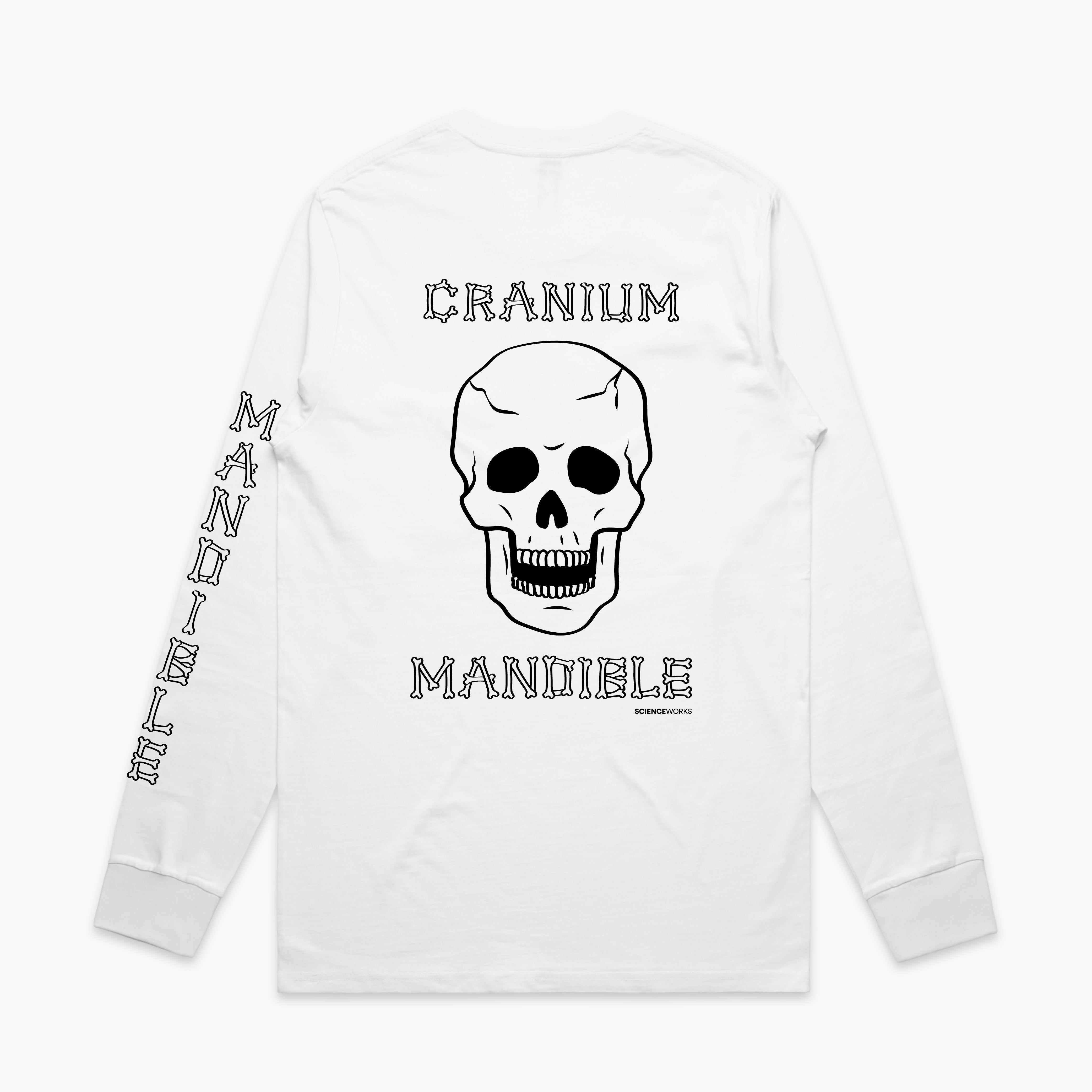 The back view of a white adult's long sleeve tee. MANDIBLE is written in a font made of bones down the back of the left arm. CRANIUM MANDIBLE is written in the same bone font across the centre back, with a large human skull below and above the two words respectively. Scienceworks is printed in a small font to the bottom right of the word MANDIBLE on the back.